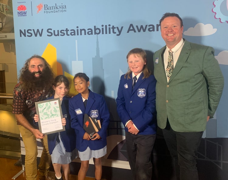 Photo of Costa Georgiadis with Belltrees students principal, holding an award